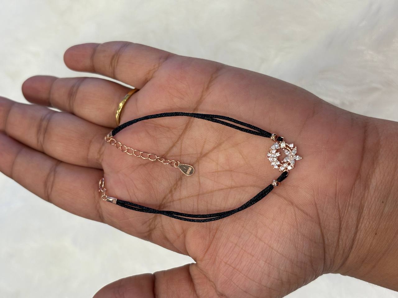 Silver black rope flower bracelet with rose gold finish
